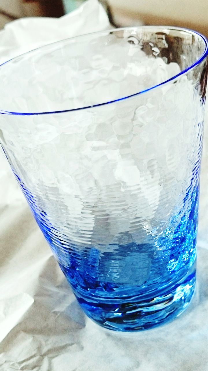 indoors, blue, close-up, still life, glass - material, high angle view, table, refreshment, drinking glass, part of, drink, transparent, reflection, no people, container, food and drink, glass, plastic, directly above, water