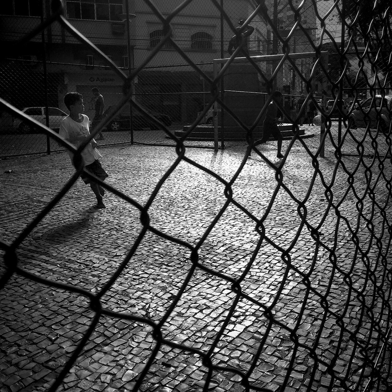 CHAINLINK FENCE SEEN THROUGH CHAINLINK FENCE