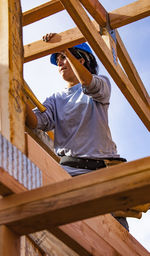 Low angle view of man looking at construction site