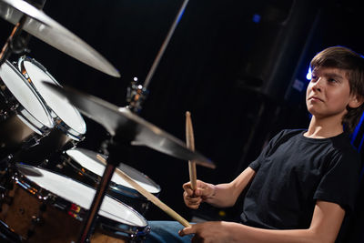 Boy playing drum at orchestra