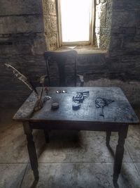 Abandoned table by window