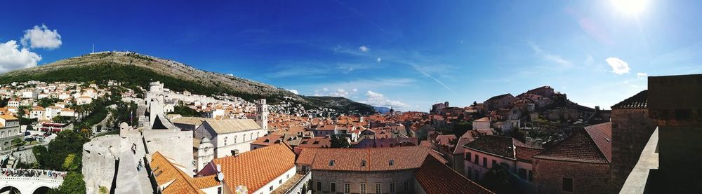 Panoramic view of town against blue sky