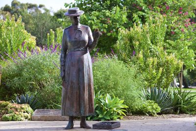 Statue amidst plants in garden