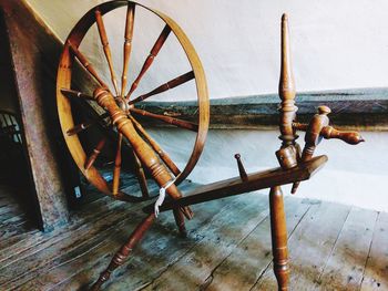 High angle view of rusty wheel on wooden floor