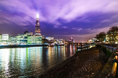 Illuminated buildings in city at waterfront