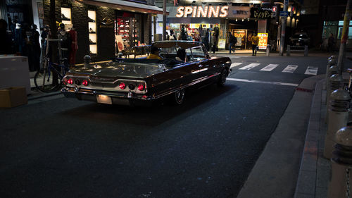 Cars on city street at night