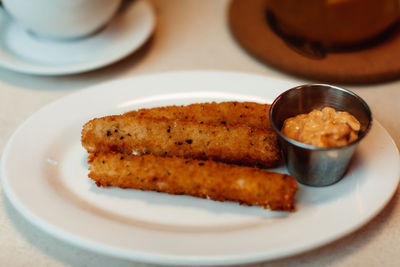 Deep fried cheese sticks with mayonnaise cream. quick and tasty snack