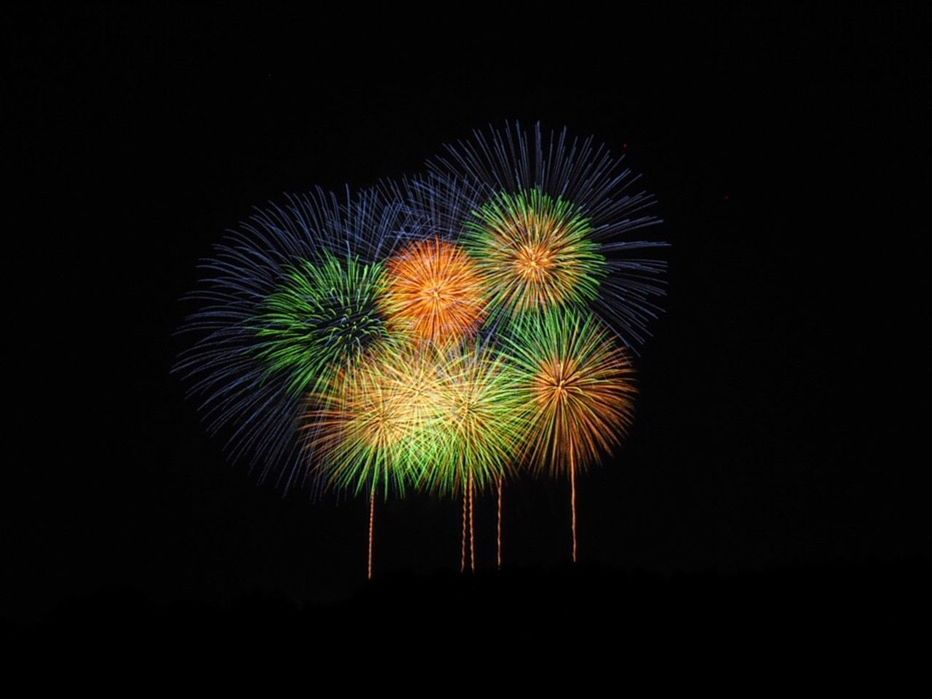 night, firework display, low angle view, firework - man made object, exploding, long exposure, celebration, arts culture and entertainment, no people, illuminated, sky, motion, multi colored, firework, outdoors, black background