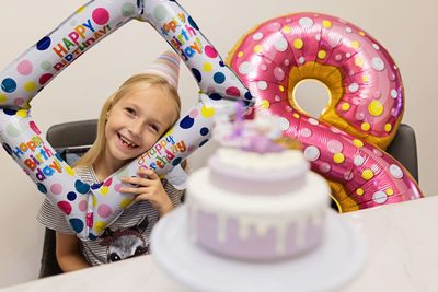 Close-up of cake with girl in background