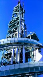 Low angle view of modern building against clear blue sky