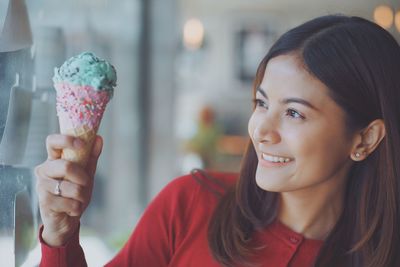 Close-up of young woman holding ice cream cone