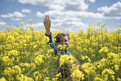 Kids have fun in blooming rapeseed field in spring