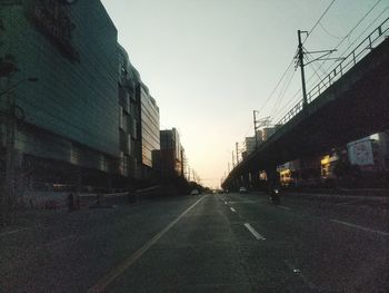 Road amidst buildings against sky in city