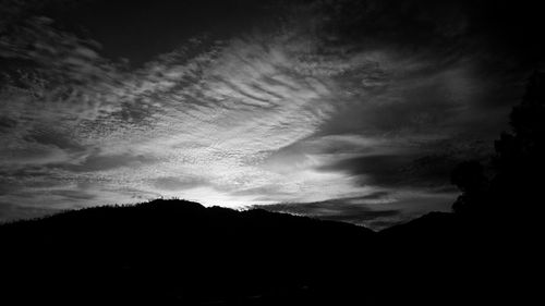 Scenic view of mountains against cloudy sky