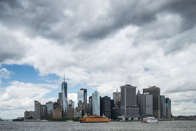 View of cityscape against cloudy sky