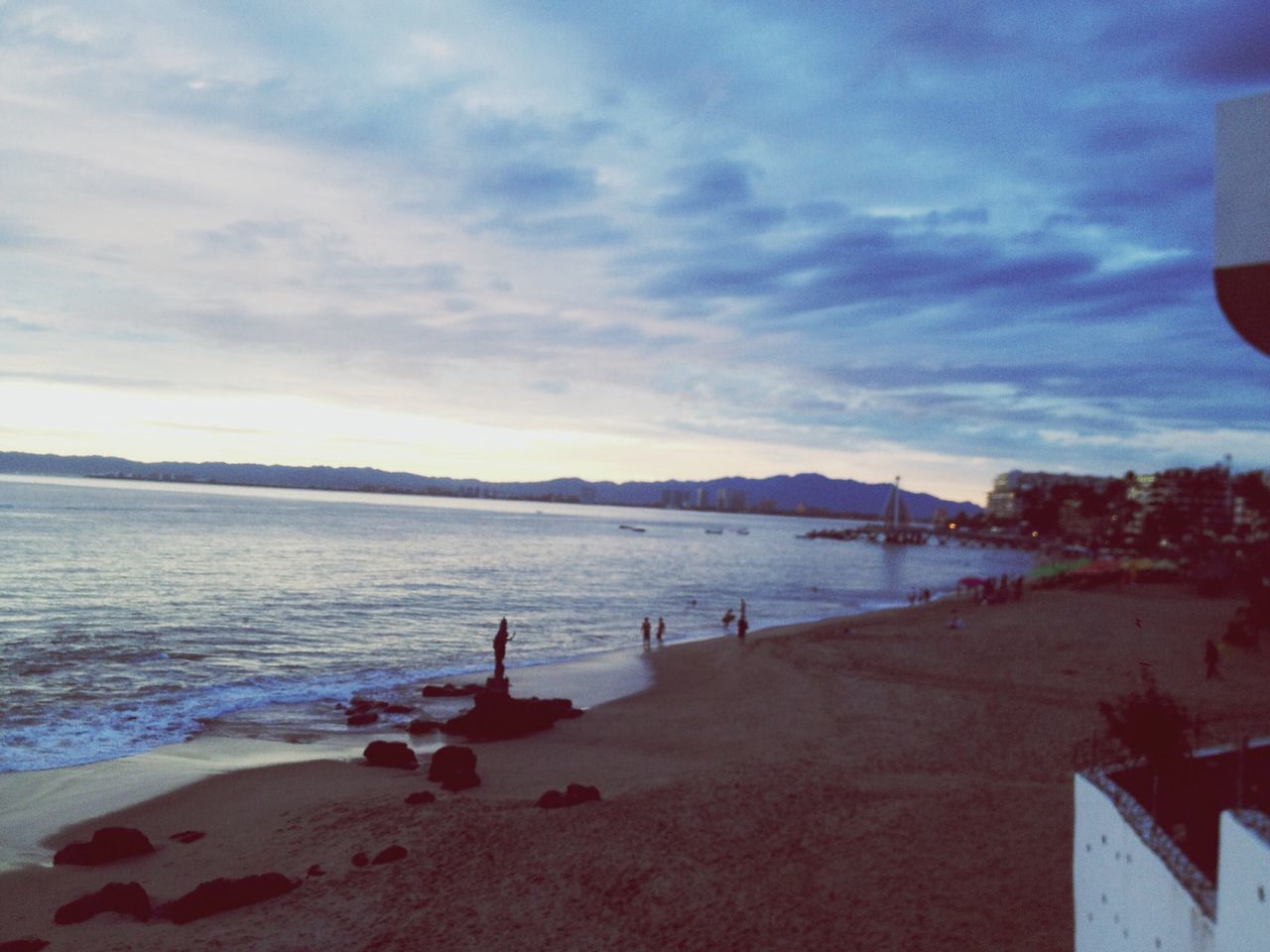 water, sky, beach, sea, cloud - sky, shore, built structure, sand, scenics, tranquility, nature, tranquil scene, outdoors, building exterior, incidental people, cloud, architecture, beauty in nature, sunset