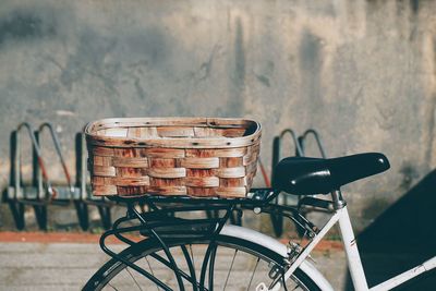 Bicycle in basket against wall