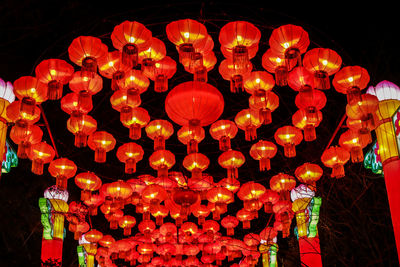 Low angle view of illuminated lanterns hanging at night