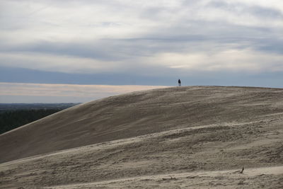 Man standing on desert against sky
