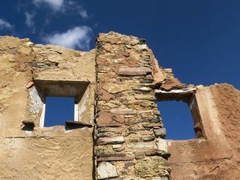 Low angle view of old ruins against sky