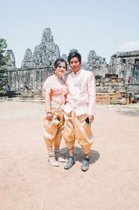 Smiling young couple against the sky