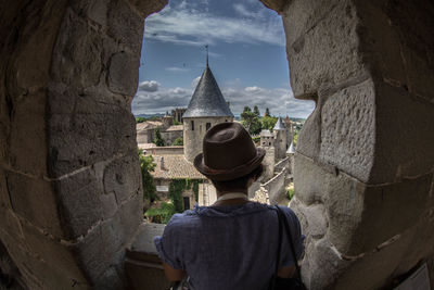 Rear view of man standing outside temple