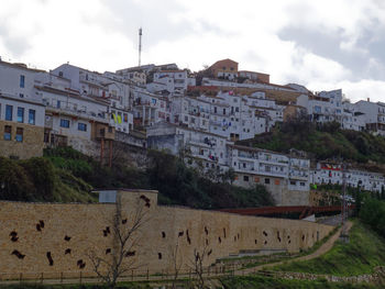 Buildings in town against sky