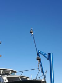 Low angle view of street light against clear blue sky