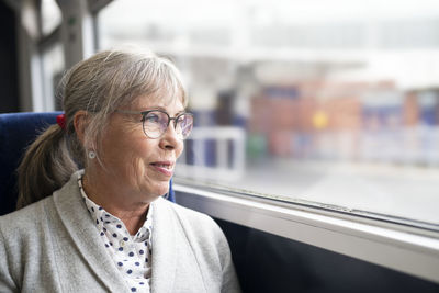 Woman in bus looking through window