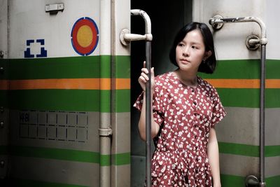 Young woman standing on doorway