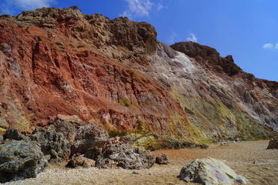 Scenic view of rocky hills against blue sky