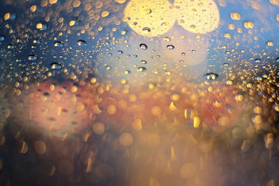 Close-up of wet glass window during rainy season