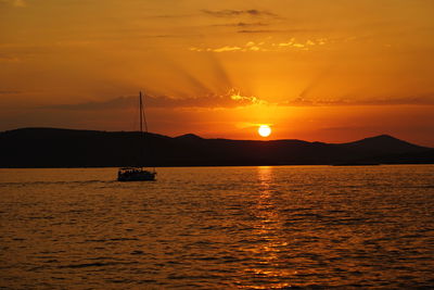 Scenic view of sea against orange sky