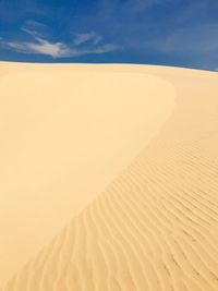 Sand dune in desert against sky