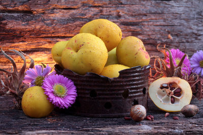 Close-up of fruits and flowers on table