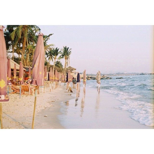 sea, water, beach, transfer print, sand, horizon over water, shore, auto post production filter, clear sky, tranquility, sky, tranquil scene, nature, scenics, built structure, day, beauty in nature, palm tree, incidental people, pier