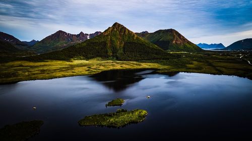 Scenic view of lake and mountains against sky