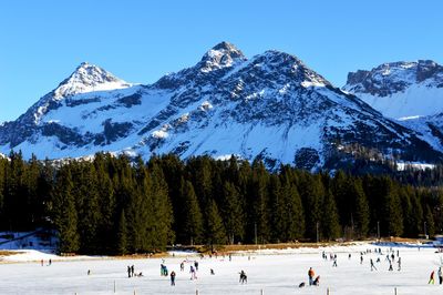 Scenic view of snow covered mountains against clear sky