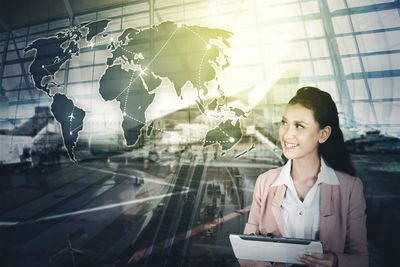 Young woman looking through window