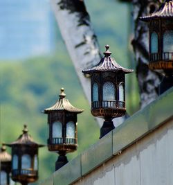 Close-up of illuminated lamp post on old building