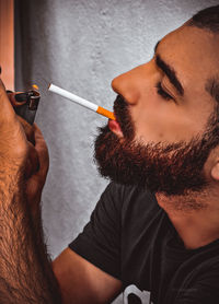 Close-up of man holding cigarette