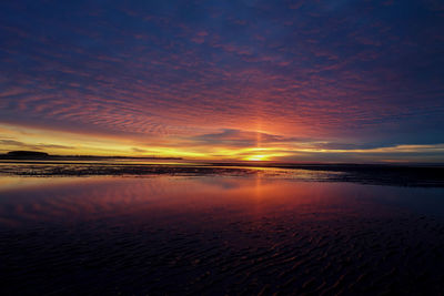 Scenic view of sea against romantic sky at sunset