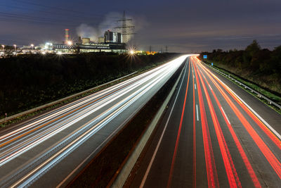High angle view of light trails on highway at night