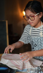 Full length of a boy holding eyeglasses