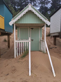 House on field against trees