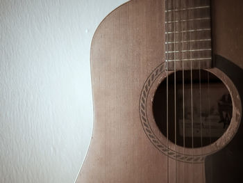 Close-up of guitar against wall