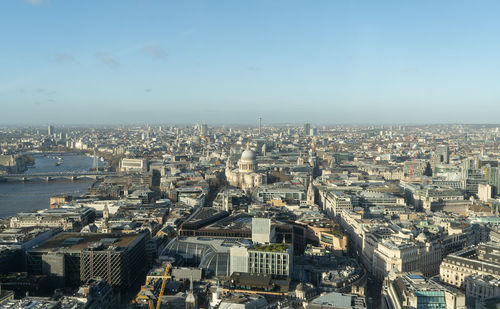 High angle view of city buildings against clear sky