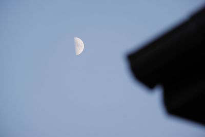 Low angle view of half moon against sky at night