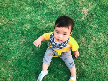 High angle view of cute baby on field