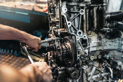 Close-up of man repairing machinery